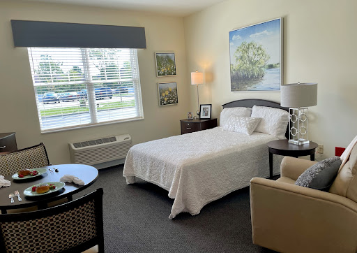 A cozy and inviting bedroom with natural light, featuring a comfortable bed, stylish furniture, and decorative artwork.
