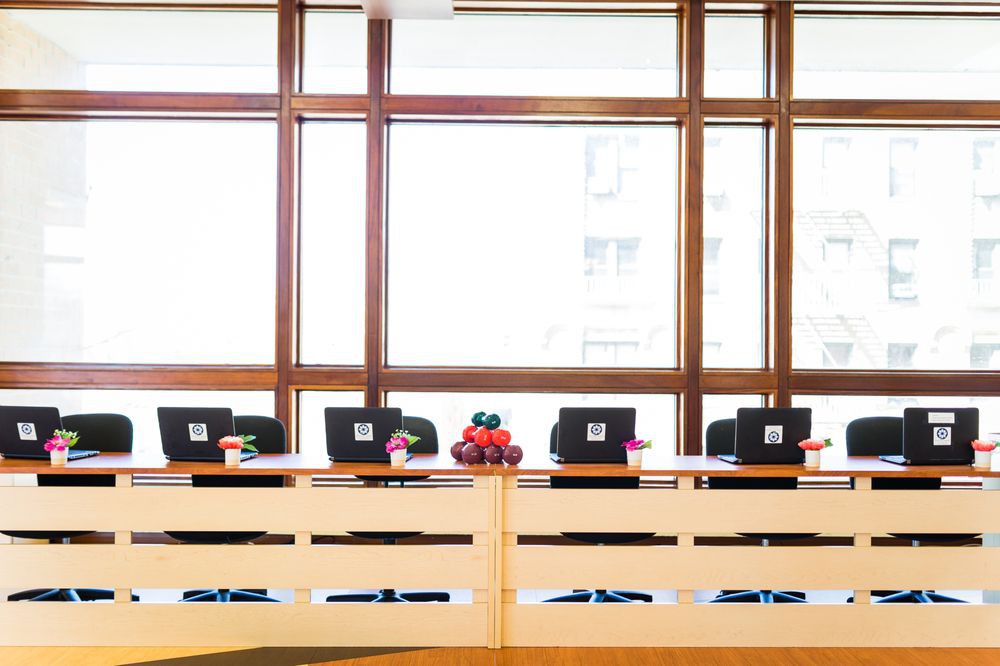 A well-organized conference room with laptops set up for a meeting.