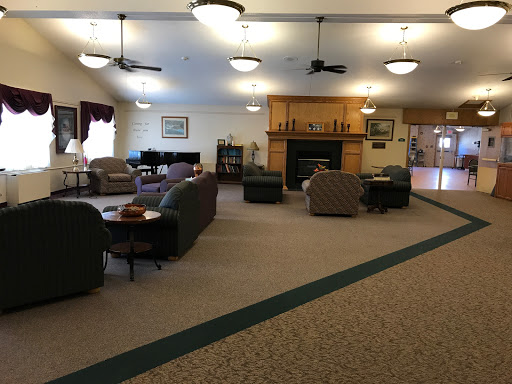 A cozy lounge area featuring comfortable seating and a warm fireplace.