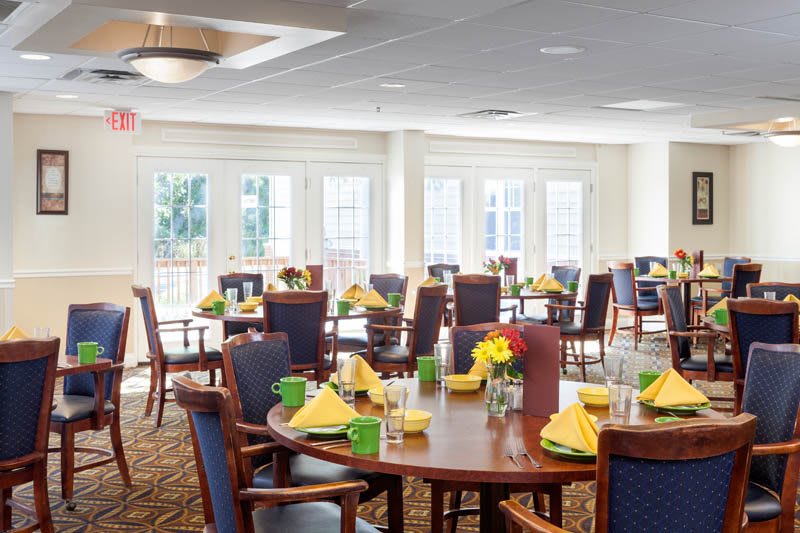 A bright and spacious dining room with tables set for a meal.