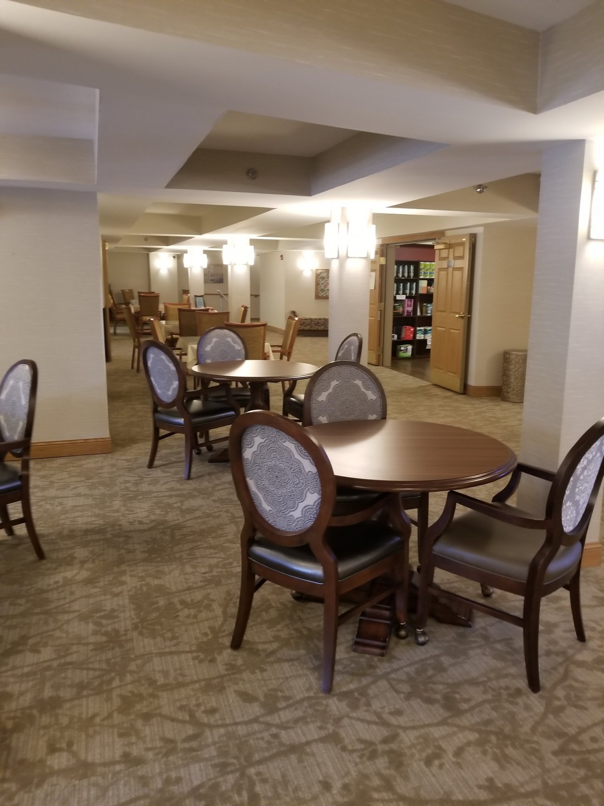 An elegantly furnished indoor dining area with wooden tables and chairs.
