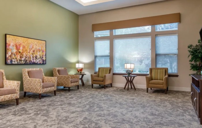 A cozy waiting room with comfortable chairs and warm lighting.