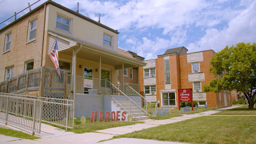 A view of a building with visible signage and an American flag in front.