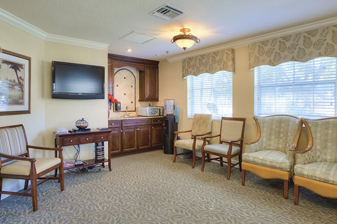 A cozy living room with comfortable seating and a mounted TV.