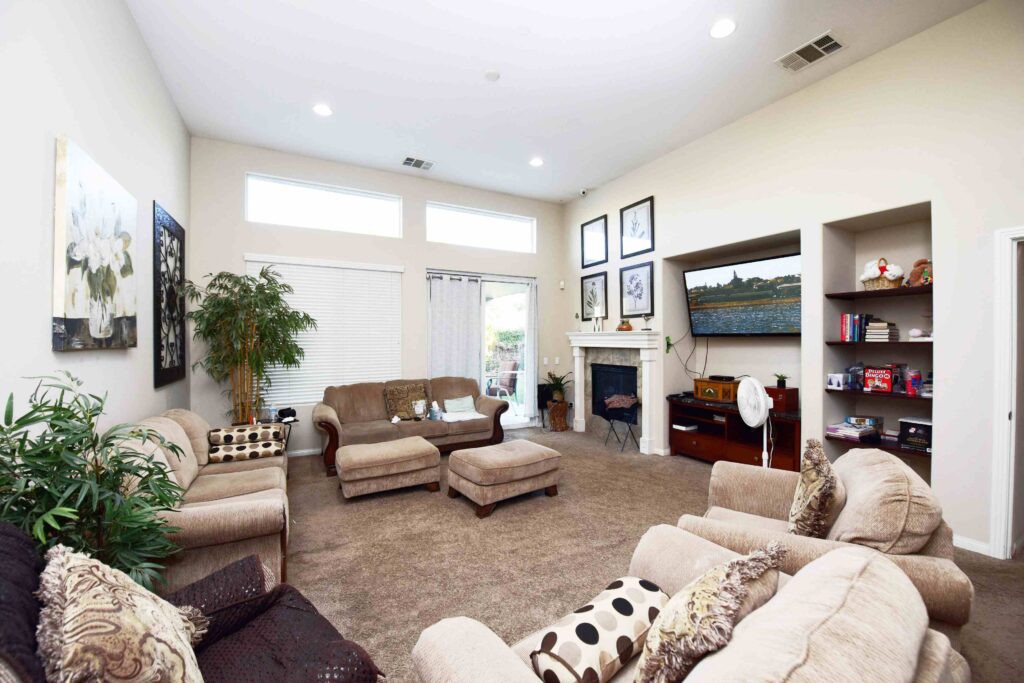 A modern living room with comfortable seating and a cozy fireplace.