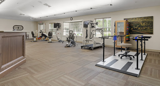 A spacious gym featuring various exercise machines and equipment for workouts.