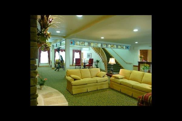 Spacious and elegantly designed living room with comfortable sofas and a grand staircase.