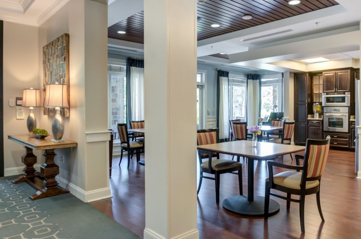A well-lit dining area featuring tables and chairs with elegant interior design.