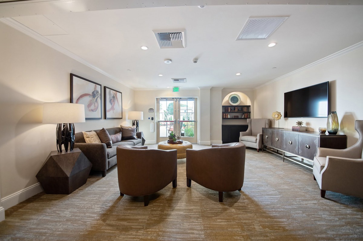 A modern and elegantly decorated living room with comfortable seating and tasteful art pieces.