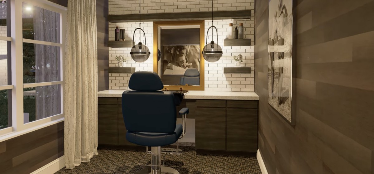 A vintage-style barber shop interior with a central barber chair, illuminated by hanging lights against a brick wall backdrop.
