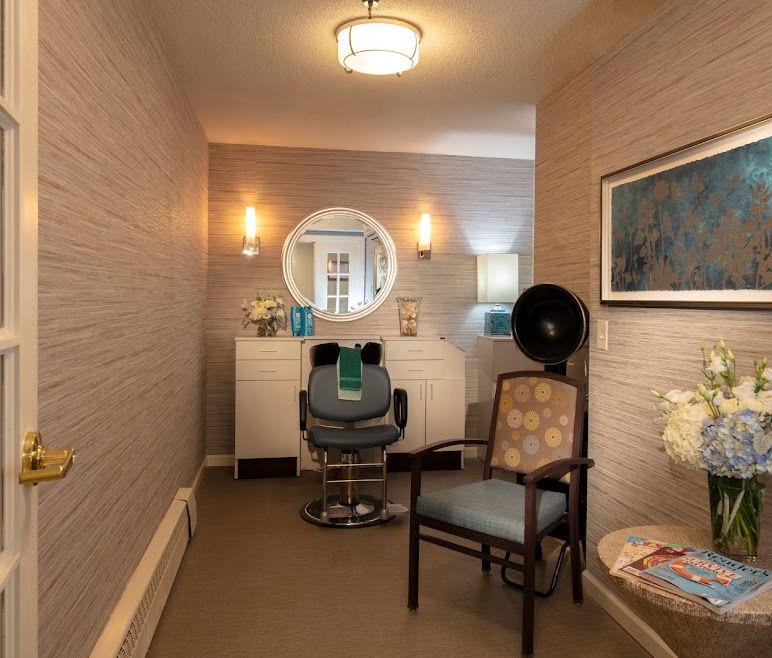 A cozy salon space with a styling chair and mirror, surrounded by elegant decor and soft lighting.