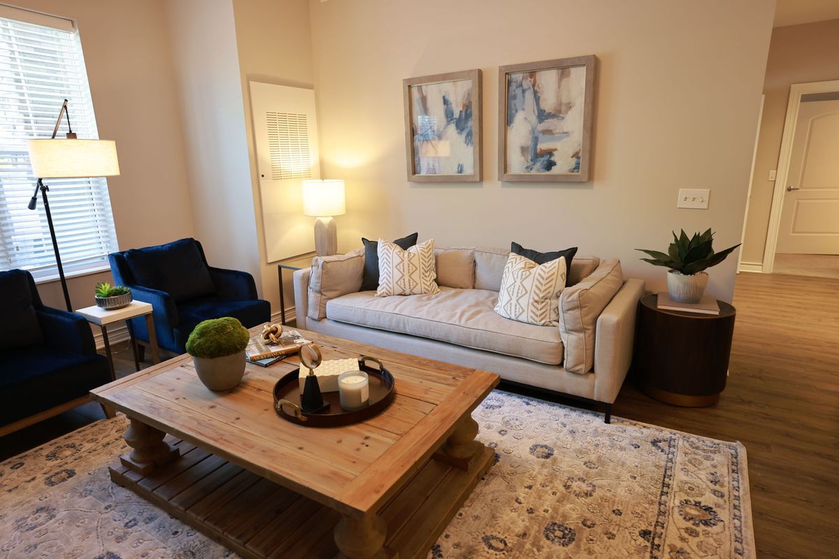 A cozy living room featuring a comfortable sofa, wooden coffee table, and elegant decor.