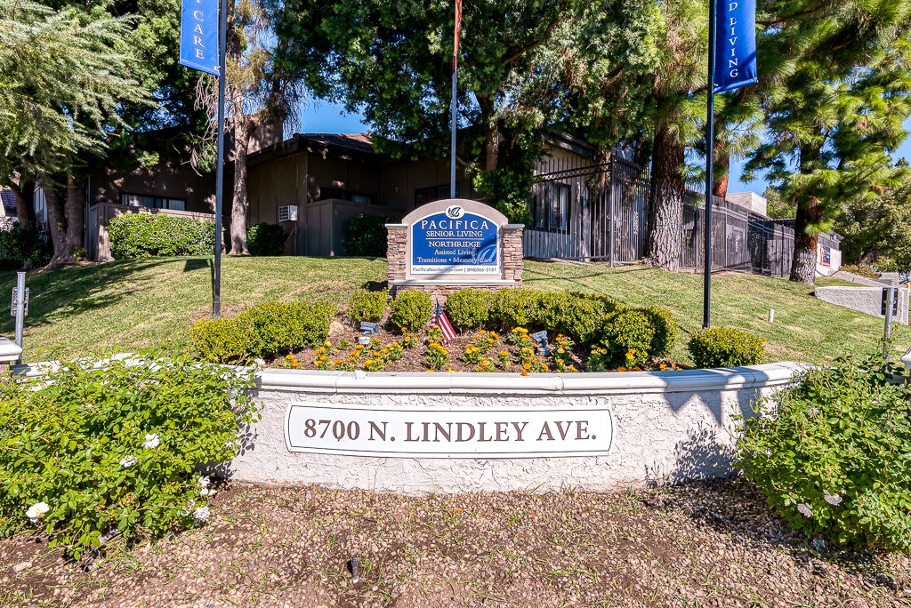Image of an apartment complex entrance with signage and landscaping at 8700 N. Lindley Ave.