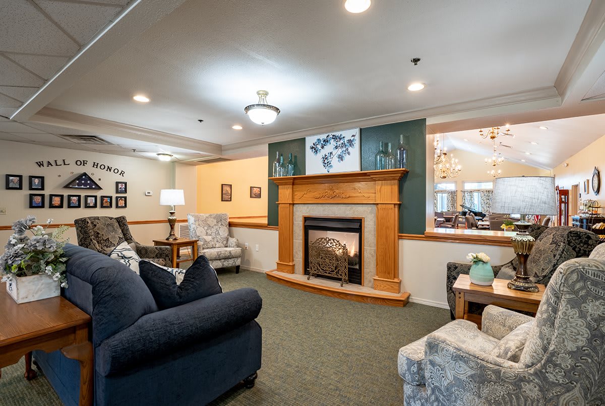 A cozy living room featuring a fireplace and comfortable seating arrangements.