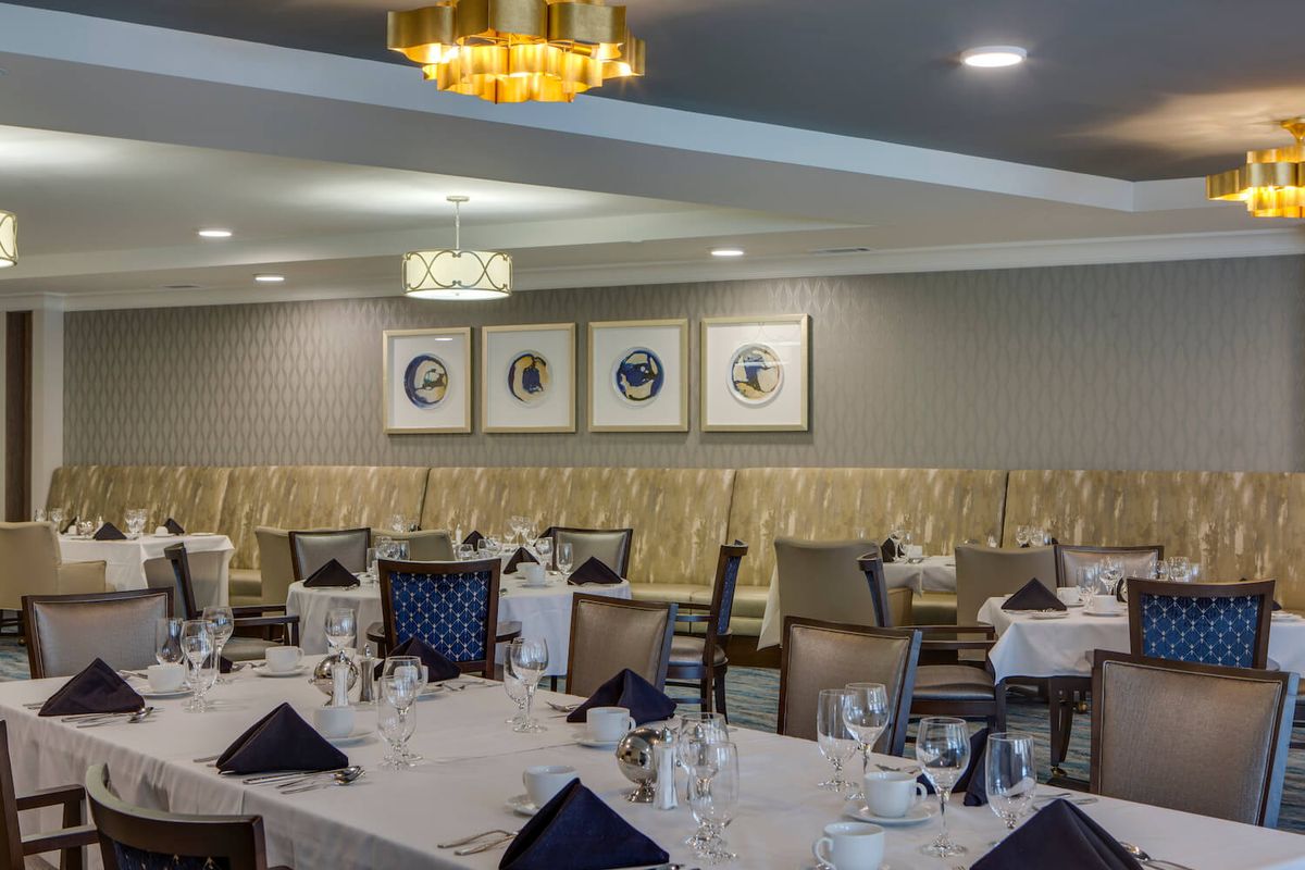 An elegant restaurant dining room with neatly arranged tables and tasteful decor.