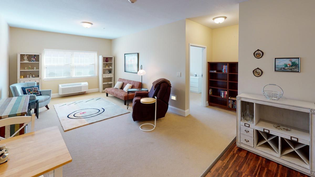 A cozy living room with comfortable seating and a bookshelf.