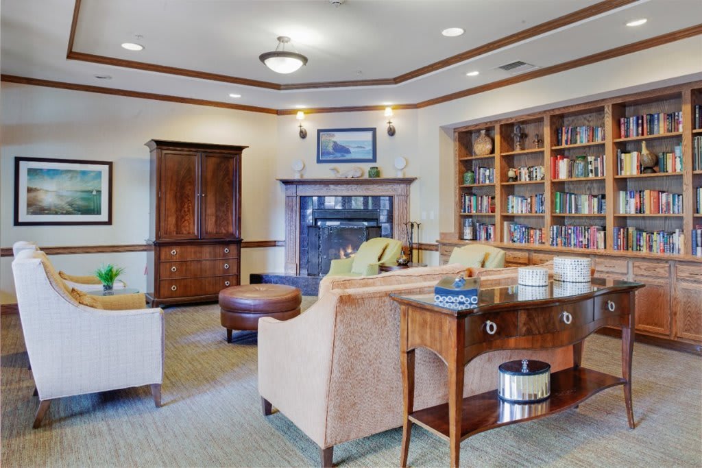 A cozy living room with comfortable seating and a well-stocked bookshelf.