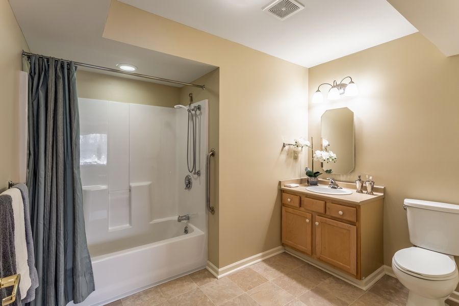 A clean, modern bathroom with a bathtub and vanity.