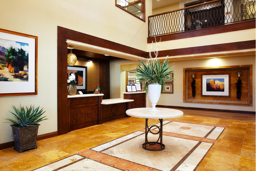 A modern hotel lobby featuring a reception desk and stylish decor.