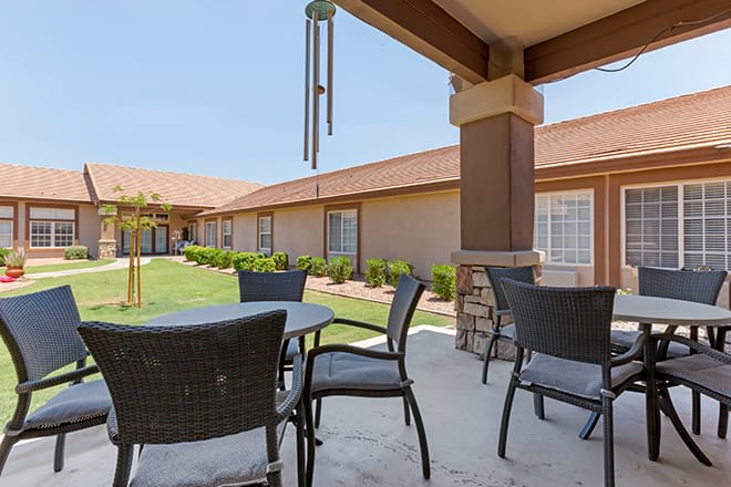 Outdoor patio area with tables and chairs in a courtyard setting.