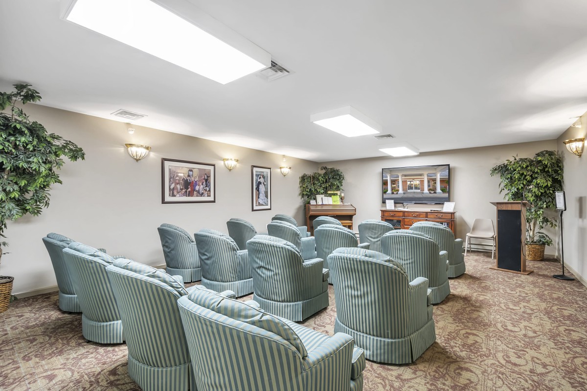 A small auditorium with comfortable seating and a screen at the front.