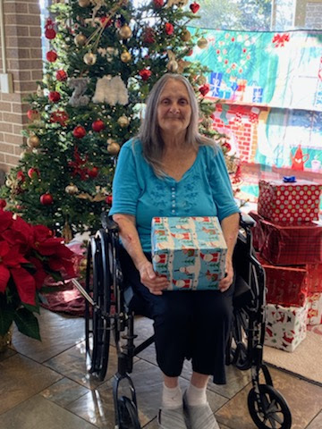 A joyful moment shared during the holiday season, surrounded by festive decorations and gifts.