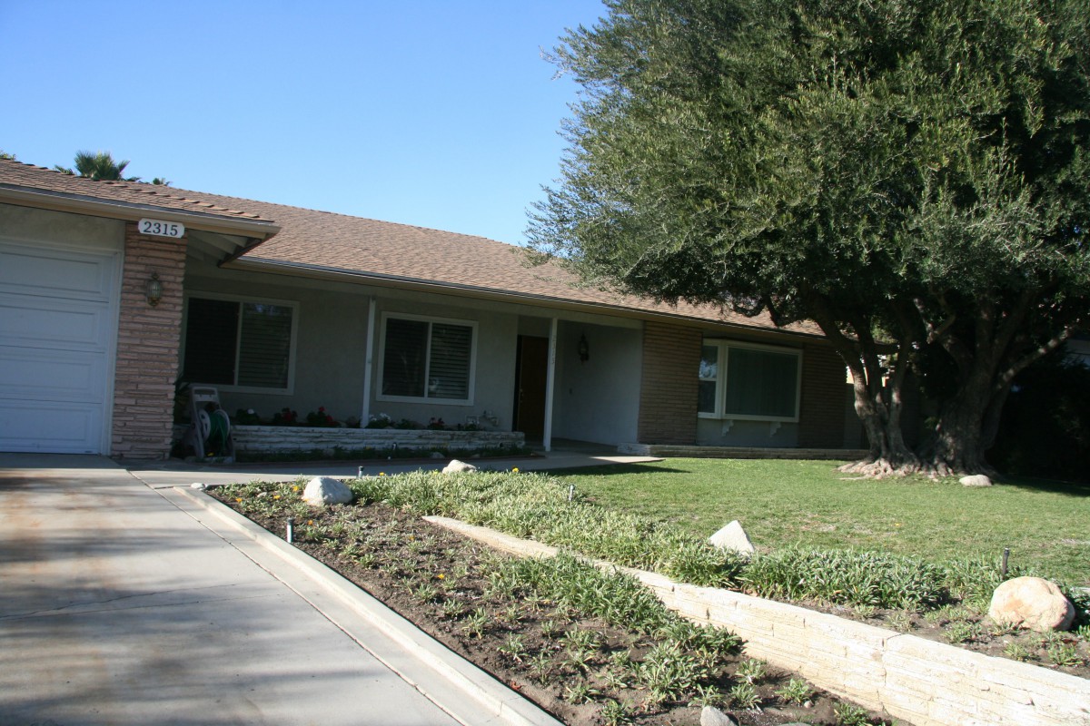 A suburban house with a garden and driveway.