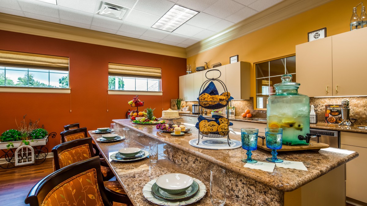 A well-decorated kitchen and dining area with a countertop set for a meal.
