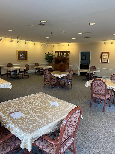 A spacious and inviting dining area with neatly set tables and comfortable chairs.