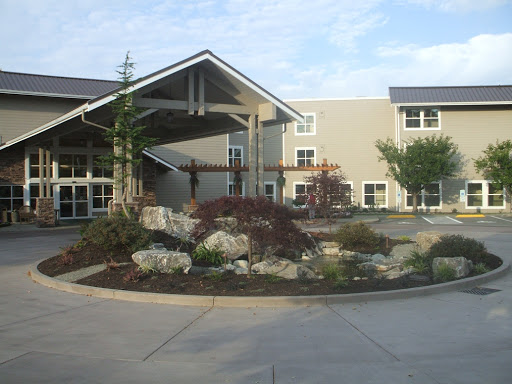 A modern commercial building with landscaped gardens and a welcoming entrance.