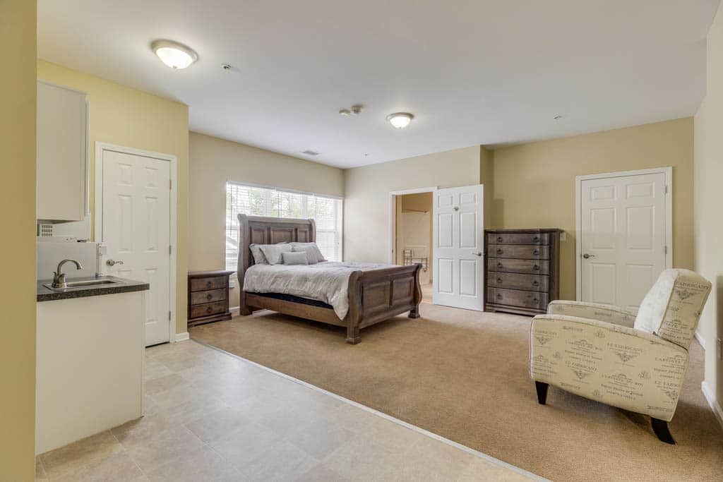 Spacious bedroom with a large bed, nightstands, and a dresser.