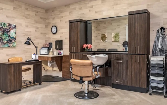 A modern hair salon interior with styling chair and mirror.