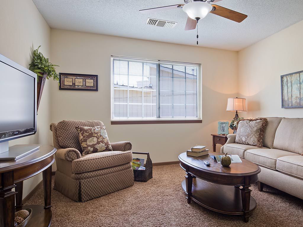 A cozy living room with comfortable furniture and warm lighting.