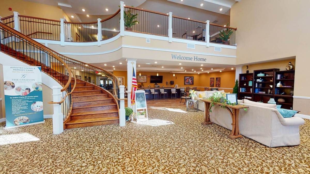 A spacious and elegantly designed lobby with a grand staircase and reception area.