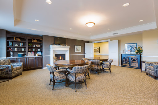 A cozy meeting room featuring elegant furniture and a warm fireplace.