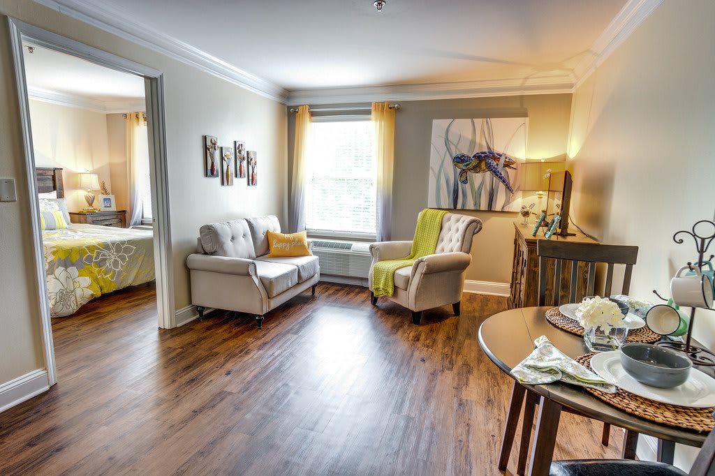 A cozy living room with modern decor, featuring comfortable seating and wood flooring.