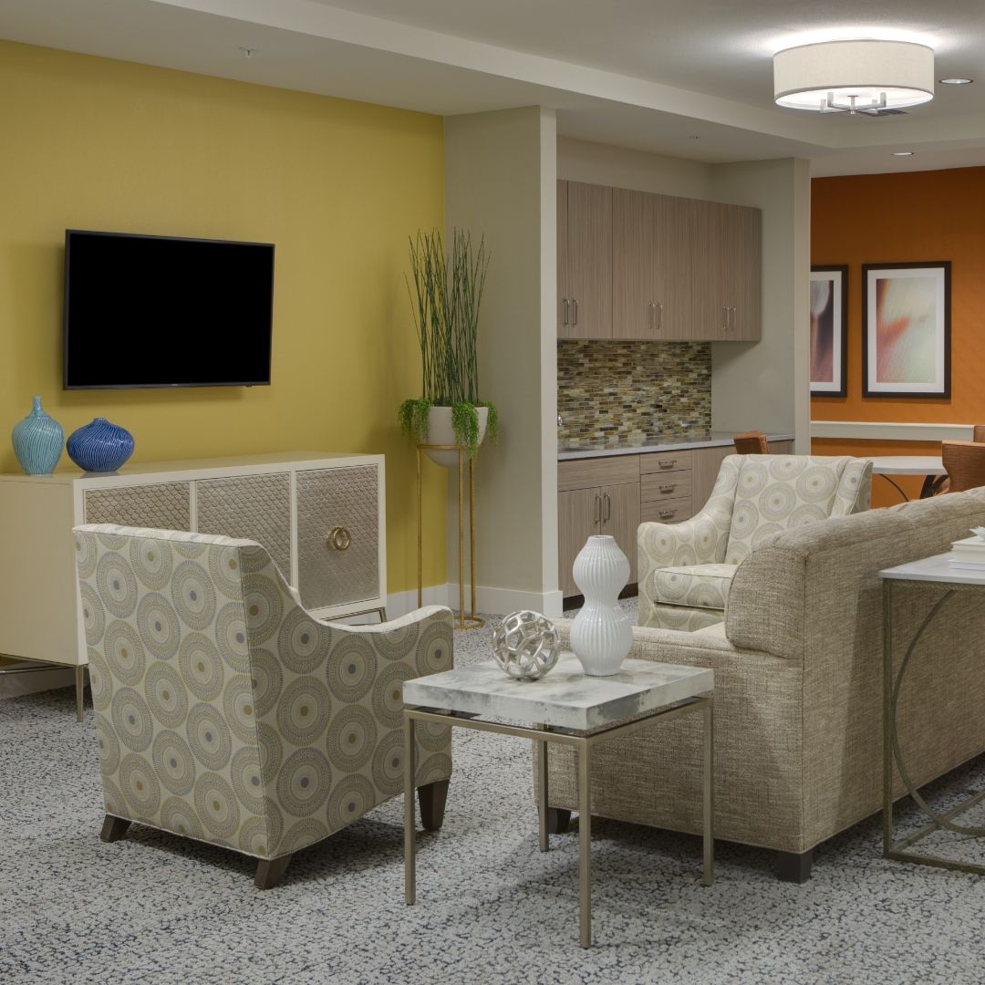 A modern living room with a cozy seating arrangement and stylish decor.