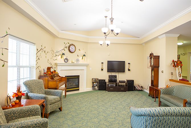 A cozy living room with a fireplace, television, and comfortable seating.