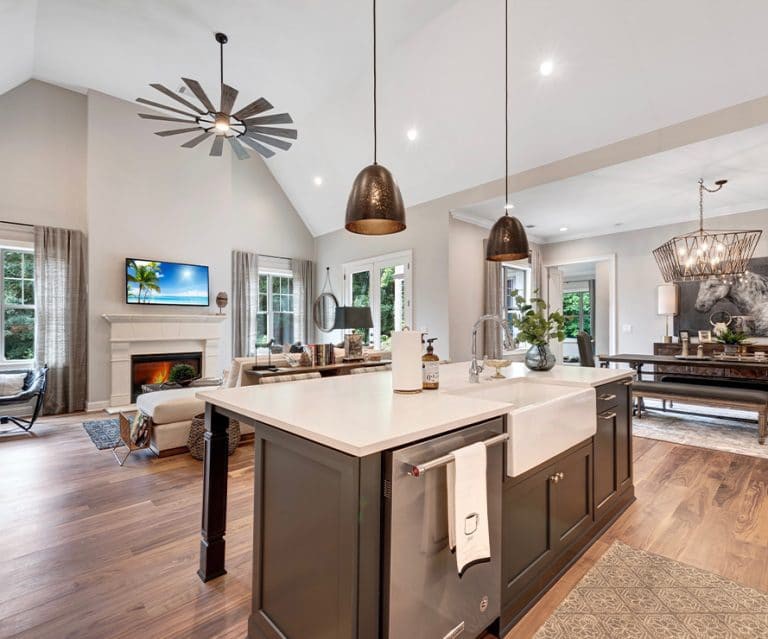 A modern open-concept kitchen with a spacious island and connected living and dining areas.