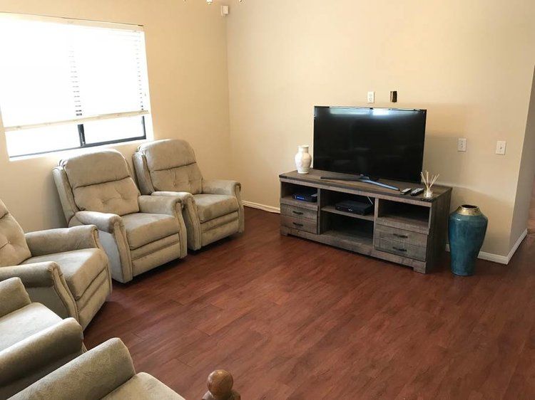 Cozy living room with reclining chairs and a television setup.