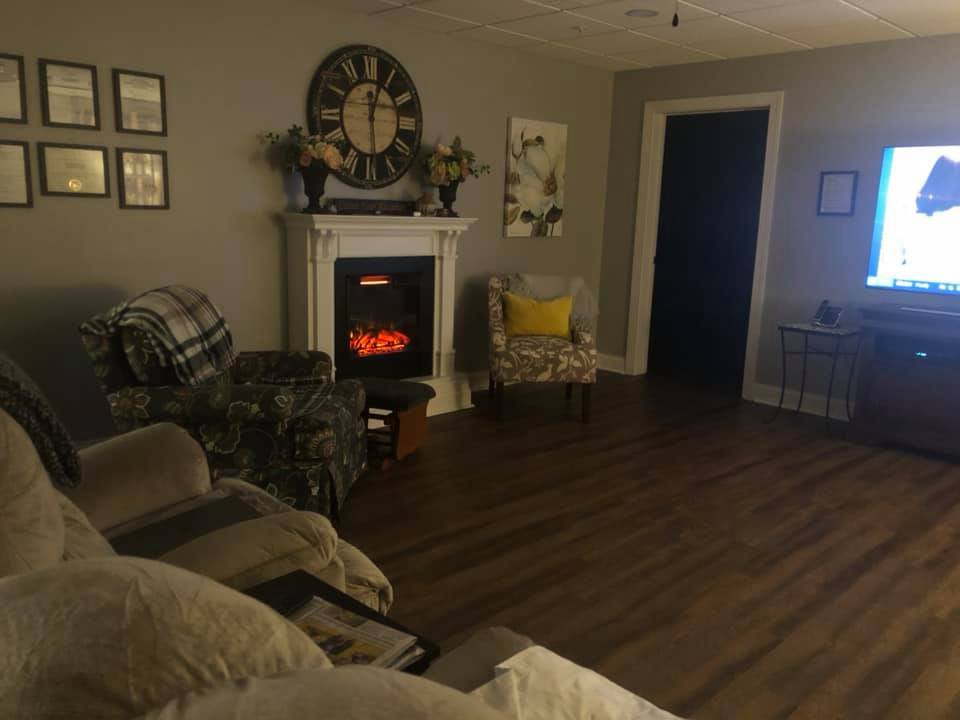 A cozy living room with a fireplace and comfortable seating.