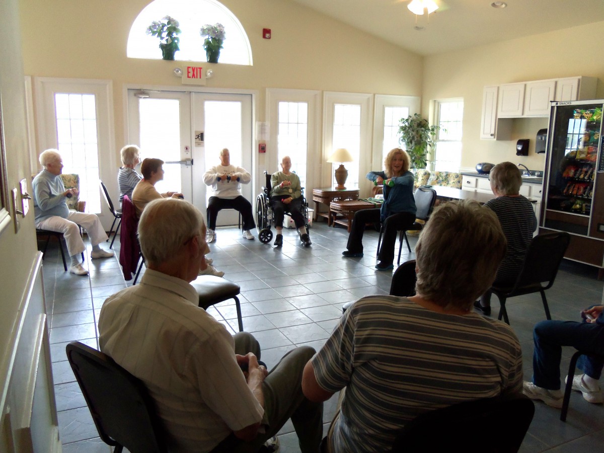 A group of people seated in a circle having a discussion in a well-lit room.