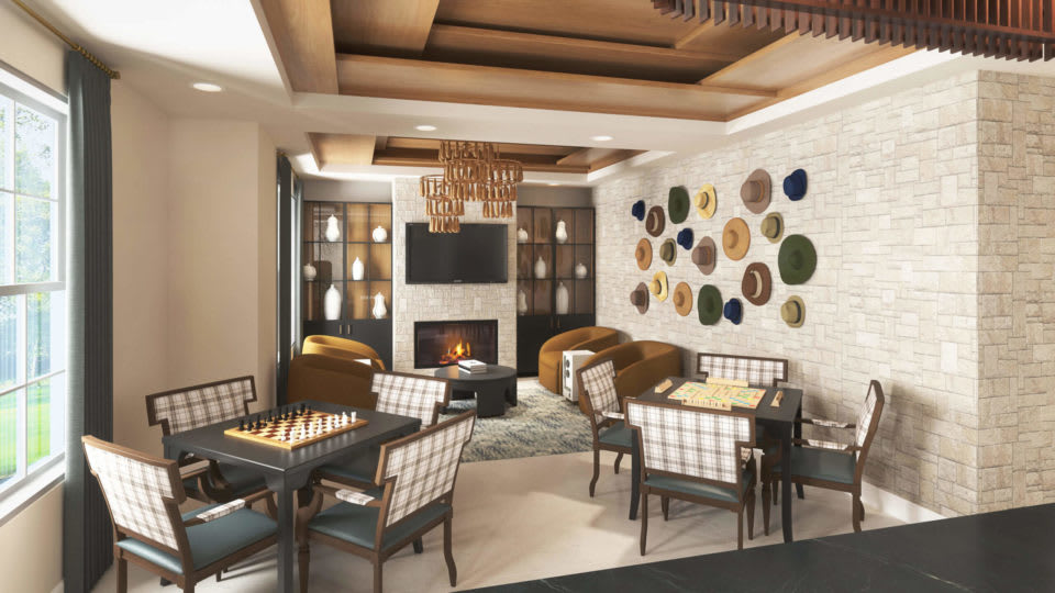 A modern living room featuring a cozy fireplace, elegant chandeliers, and stylish wall art.