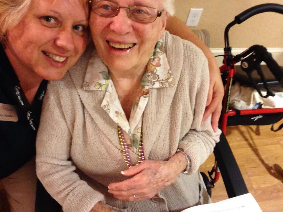 A joyful moment captured between two women, one elderly, sharing a smile together.