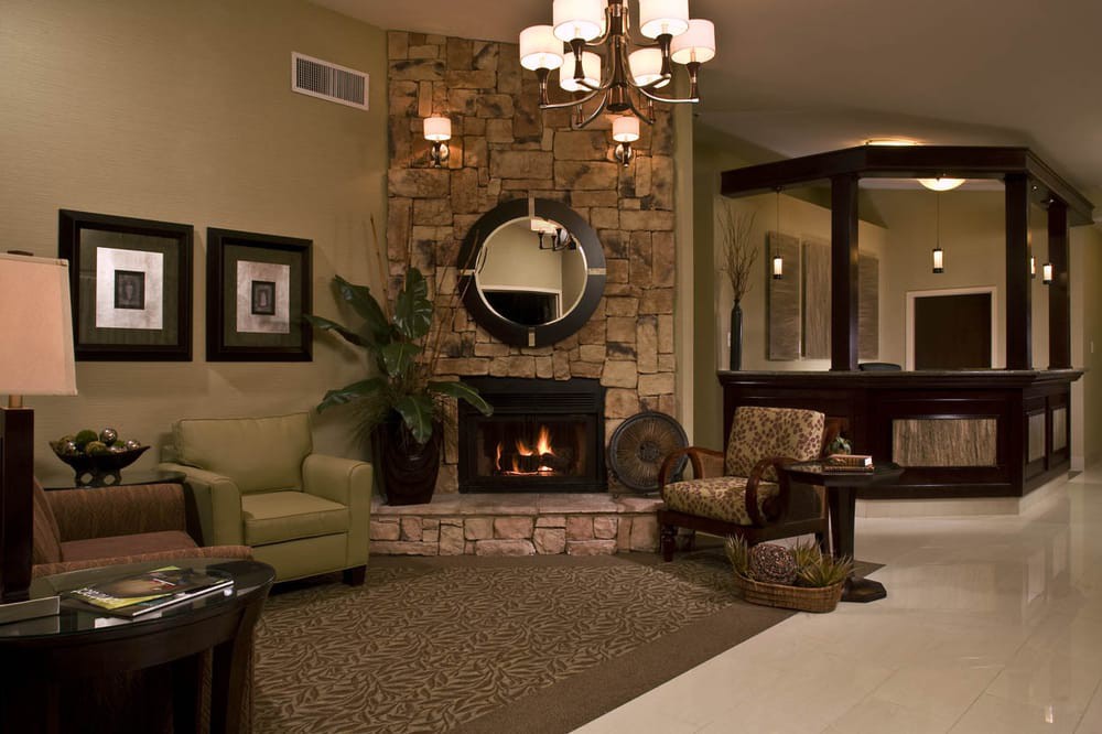 A cozy living room with a stone fireplace and elegant decor.
