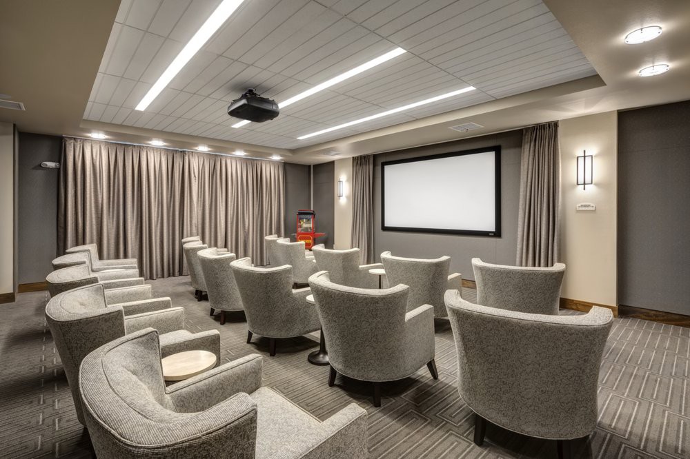 A luxurious home theater with comfortable seating and a large projector screen.