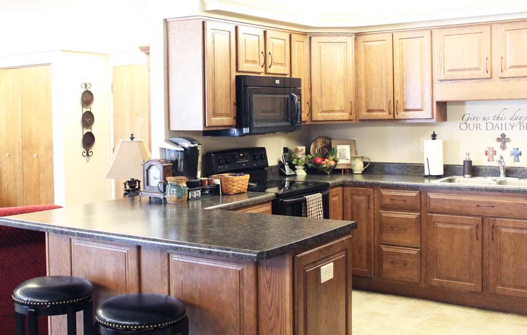 A cozy kitchen with wooden cabinets and modern appliances.