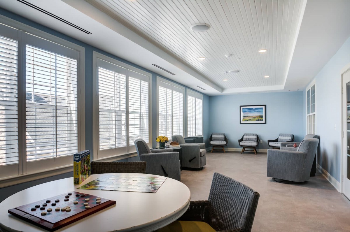 A modern waiting room with comfortable seating and large windows letting in natural light.