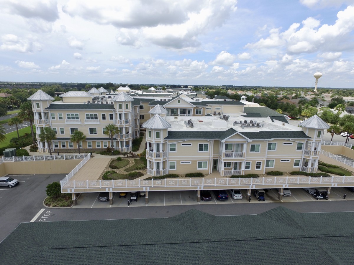 Aerial view of a residential building complex under a cloudy sky.