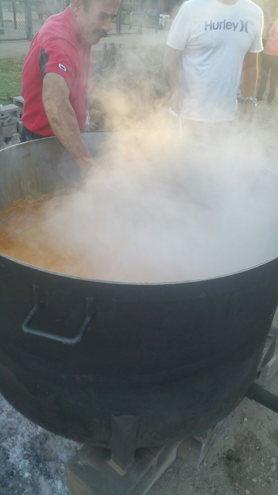 A large steaming pot being used for outdoor cooking.